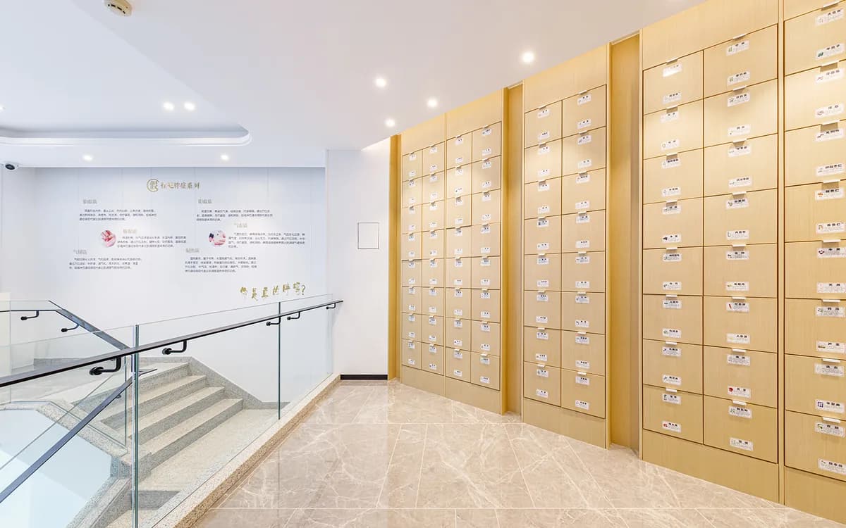 Bright reception area with a wall of traditional medicine drawers